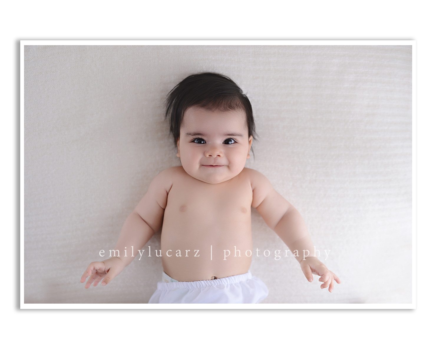 A darling 4 month old girl who had her photo taken in a yellow dress for a baby photography session in St. Louis MO